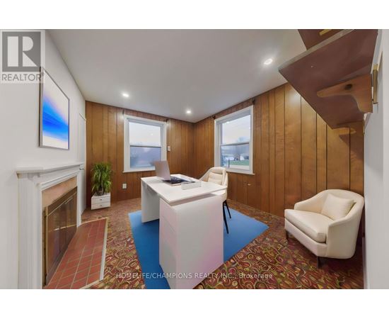 A realtor's office with a fireplace and a painting on the wall.