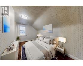 A bedroom with a large bed and a window.