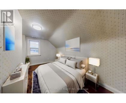A bedroom with a large bed and a window.