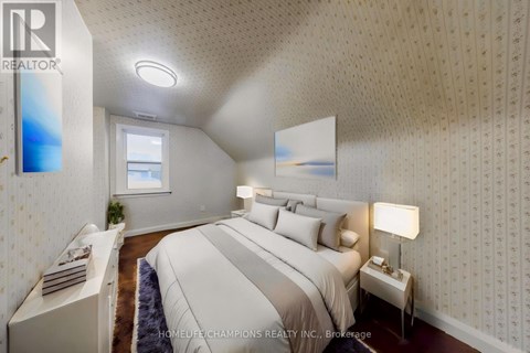 A bedroom with a large bed and a window.