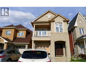 A white car is parked in front of a house with a sign that says "Bay Street Group".