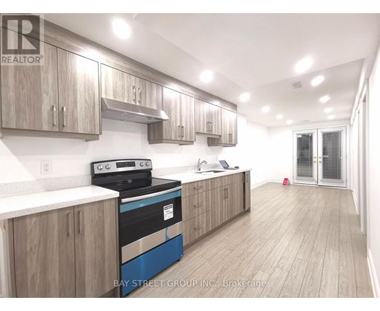 A kitchen with wooden cabinets and a blue stove top oven.