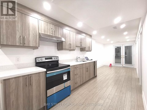 A kitchen with wooden cabinets and a blue stove top oven.