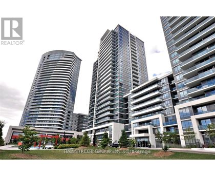 A real estate company logo is displayed in front of a modern residential building.