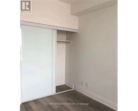 A room with a sliding door and a white wall.