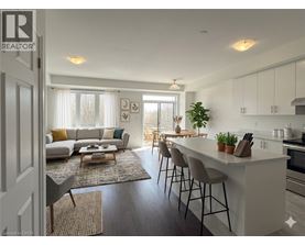 A well-lit, modern kitchen and living room with a dining area.