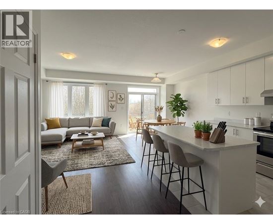 A well-lit, modern kitchen and living room with a dining area.