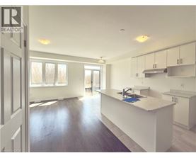 A kitchen with white cabinets and a sink.