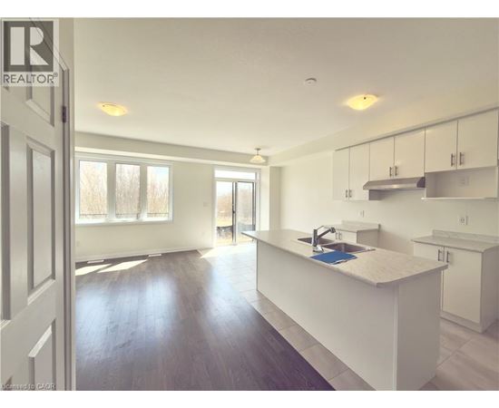 A kitchen with white cabinets and a sink.
