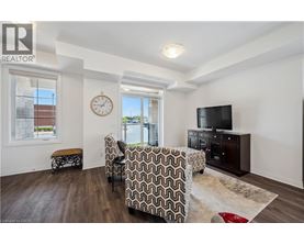 A living room with a couch, chair, and television.