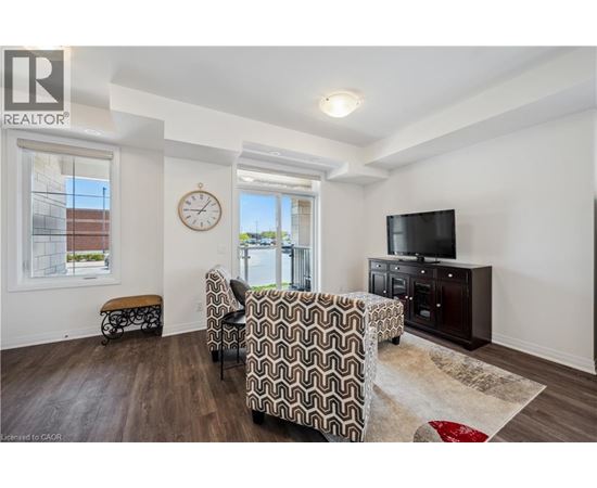 A living room with a couch, chair, and television.