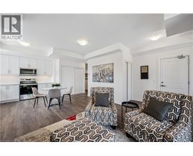 A living room with a patterned chair and a couch.