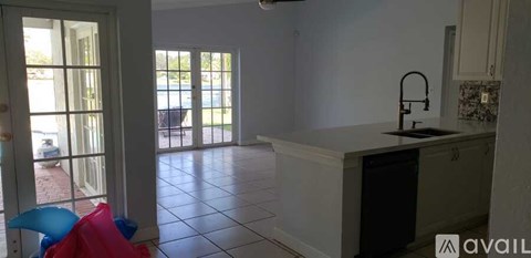 A kitchen with a white counter and a sink.