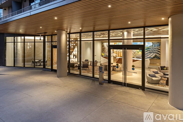 A modern building entrance with glass doors and a wooden ceiling.
