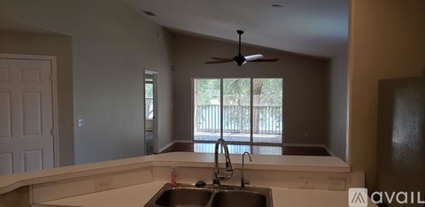 A kitchen with a sink and a window.