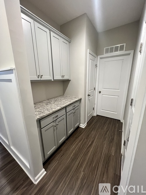 A kitchen with white cabinets and a countertop.