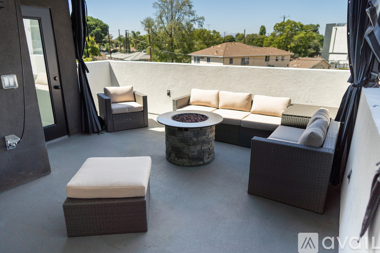 A patio with a couch, chairs, and a table.