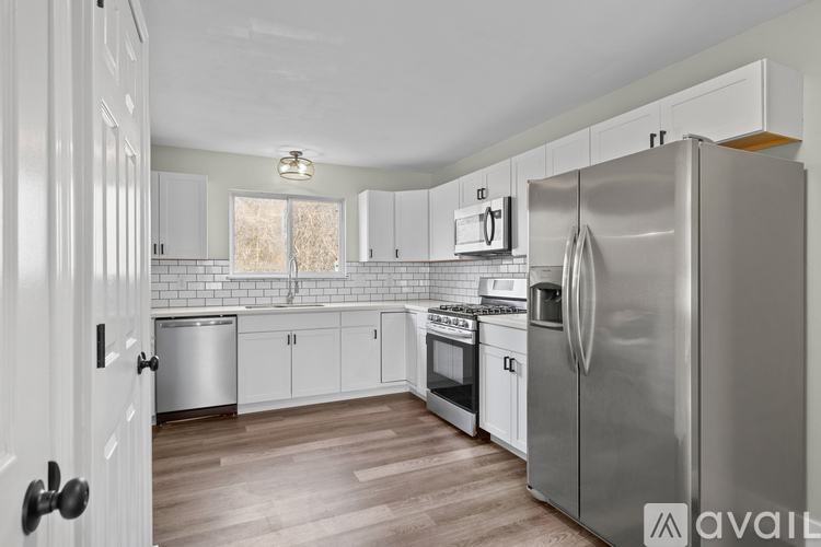A kitchen with a refrigerator, stove, and oven.