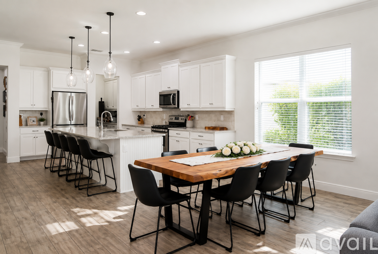 A modern kitchen with a dining table set for four.