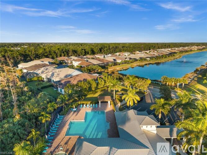 A bird's eye view of a resort with a swimming pool and palm trees.