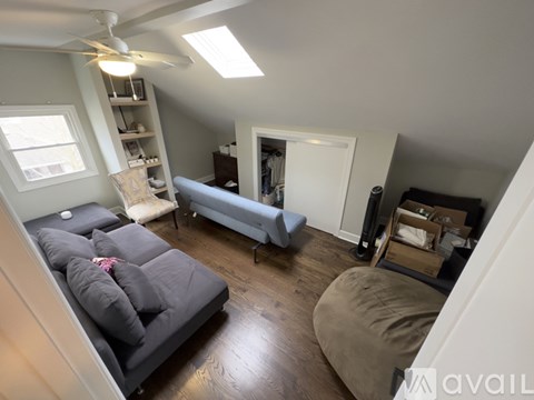 A living room with a grey couch and a white door.
