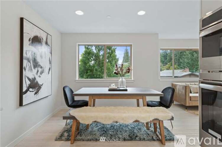 A modern dining room with a large table and chairs.