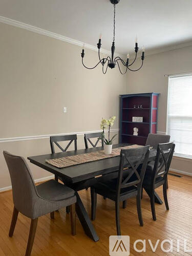 A dining room with a table and chairs.