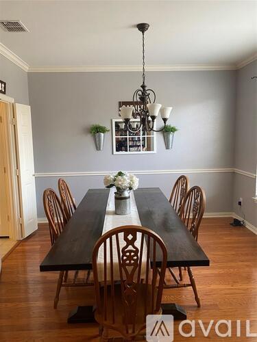 A dining room with a long table and chairs.