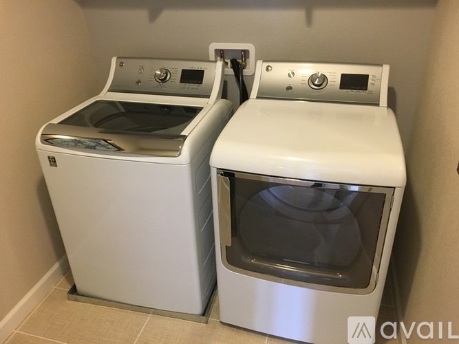 Two white ovens, one with a glass door, are side by side.