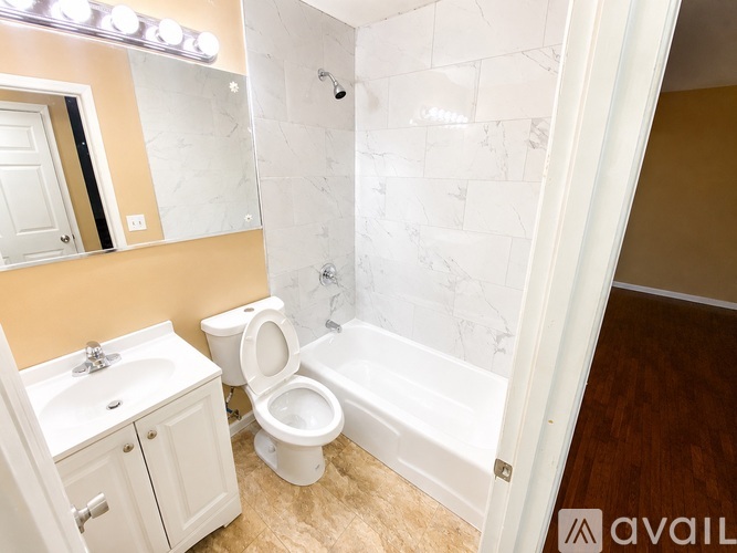 A bathroom with a toilet, sink, and bathtub.