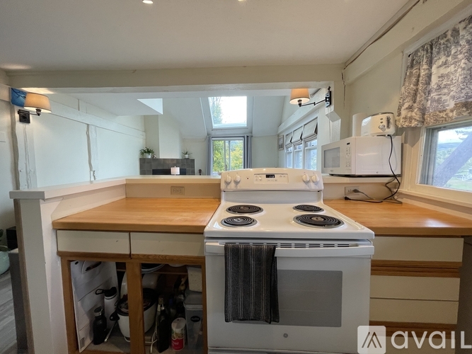 A kitchen with a stove top oven and a microwave.