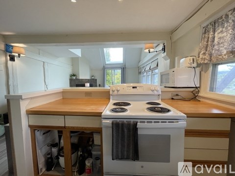 A kitchen with a stove top oven and a microwave.