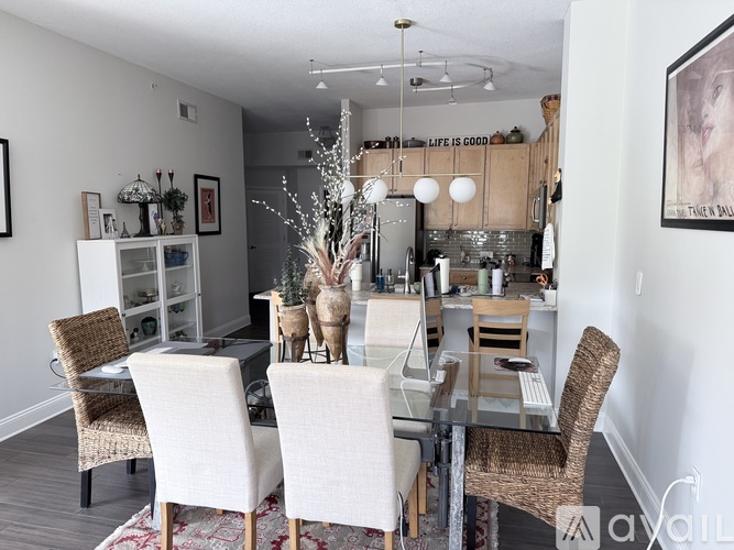A dining room with a glass table and chairs.