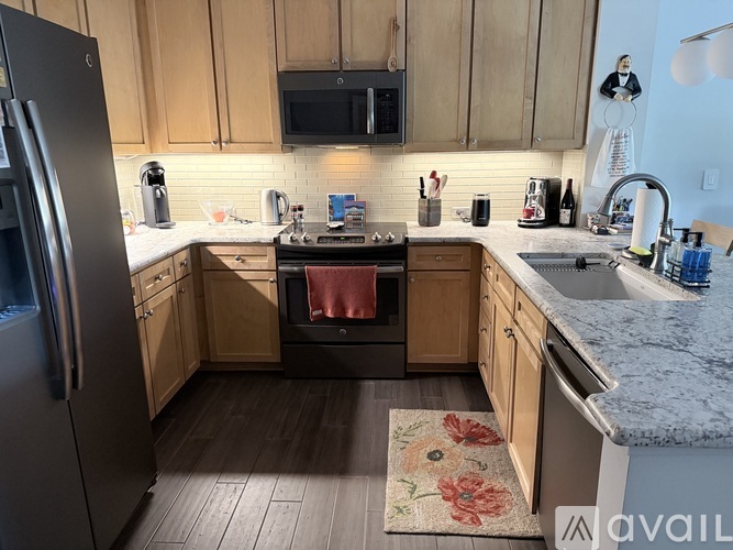 A kitchen with wooden cabinets and a granite countertop.