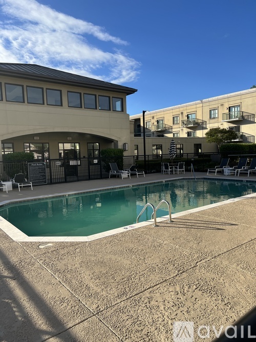 A pool with a building in the background.