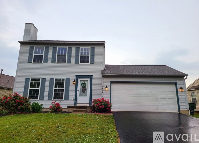 A house with a grey front and a white garage door.