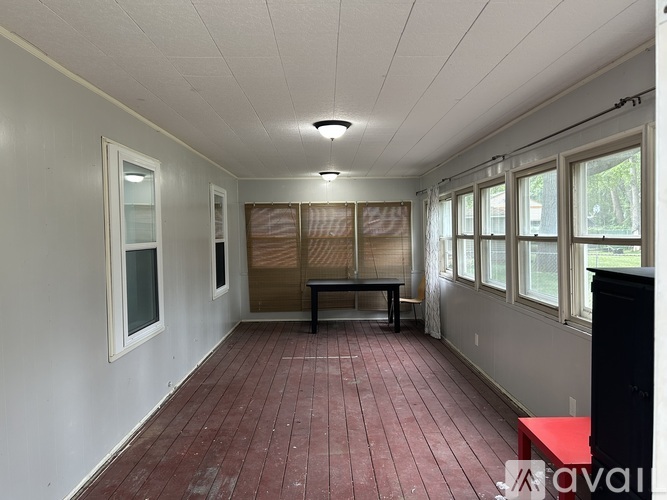 A room with a red floor and white walls.