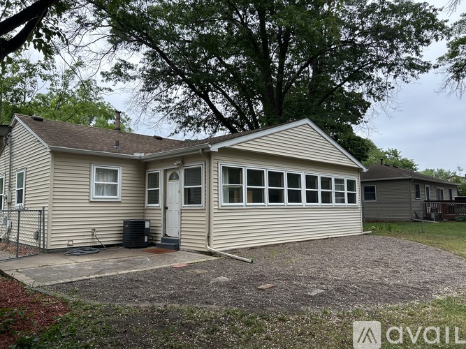 A two-story house with a garage is for sale.