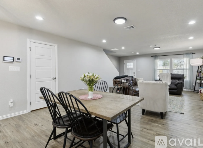 A dining room with a table set for four.