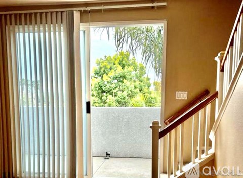 A view from inside a house looking out through a sliding glass door.