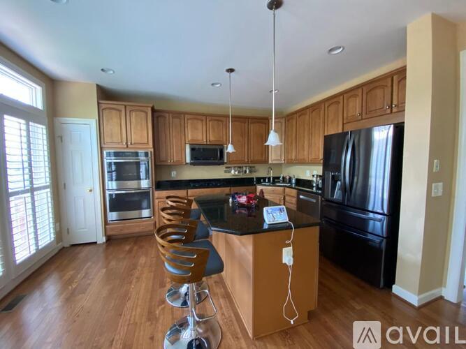 A kitchen with wooden cabinets and a black countertop.