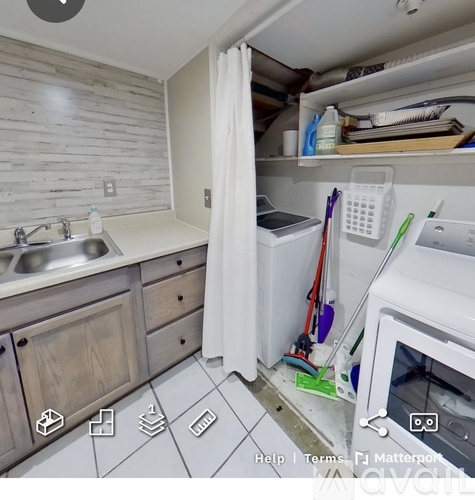 A kitchen with a white oven and a white sink.