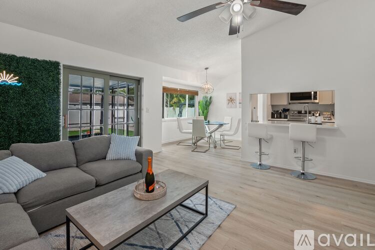 A living room with a grey sofa and a wooden coffee table.