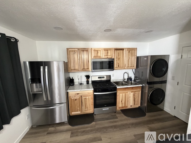 A kitchen with wooden cabinets and stainless steel appliances.
