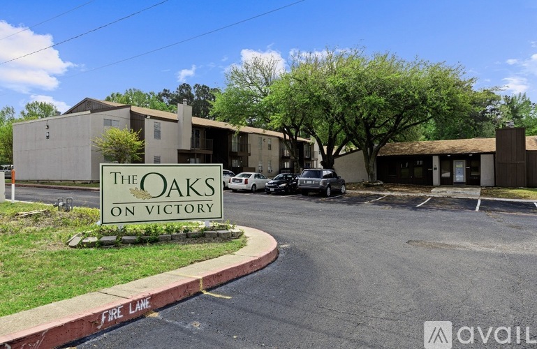The Oaks on Victory is a residential complex with a parking lot in front.