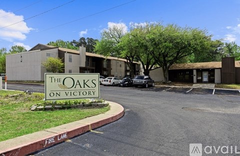 The Oaks on Victory is a residential complex with a parking lot in front.