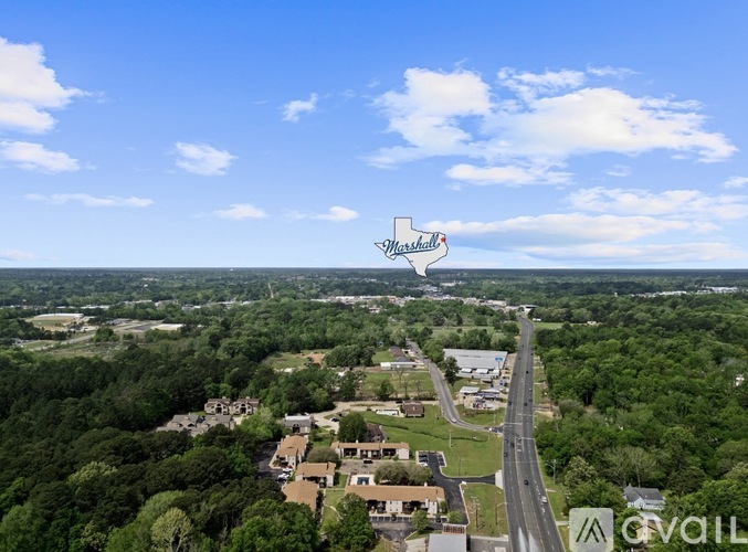A bird's eye view of a residential area with a road running through it.