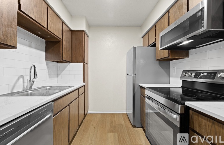 A kitchen with wooden cabinets and stainless steel appliances.