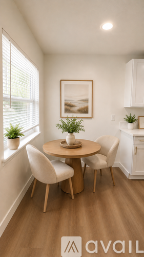 A dining area with a round table and chairs.