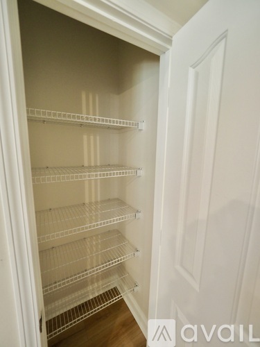 A kitchen with wooden cabinets and a white island.